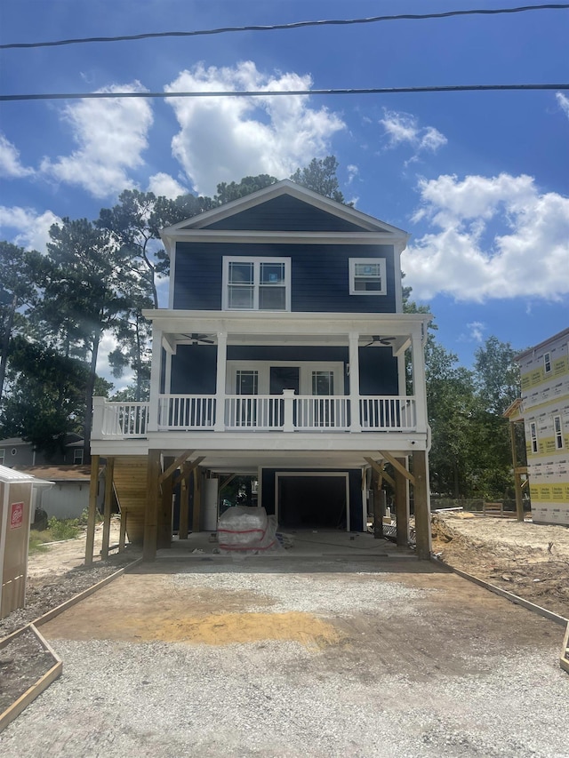 721 10th Ave S, Surfside Beach, SC 29575 - coastal inspired home with a carport, driveway, and a garage