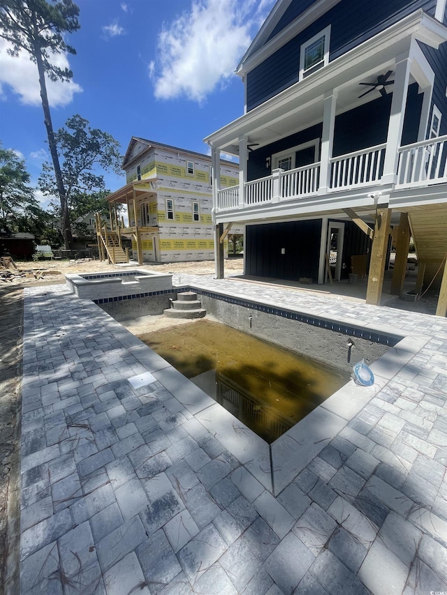 721 10th Ave S, Surfside Beach, SC 29575 - view of swimming pool with ceiling fan, stairs, a patio, and an in-ground hot tub
