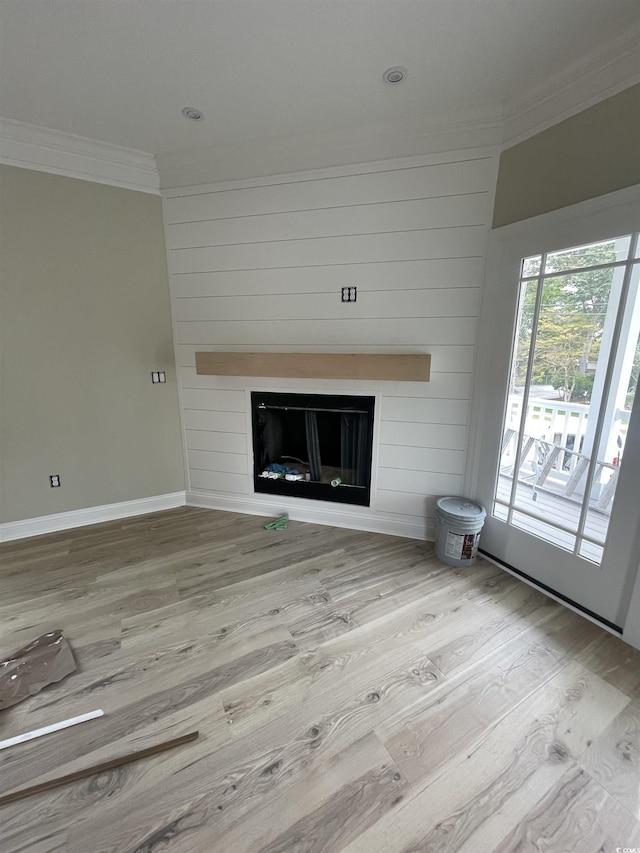 721 10th Ave S, Surfside Beach, SC 29575 - unfurnished living room featuring crown molding, a fireplace, and wood finished floors