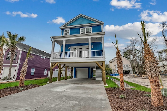 coastal inspired home featuring a porch and a garage