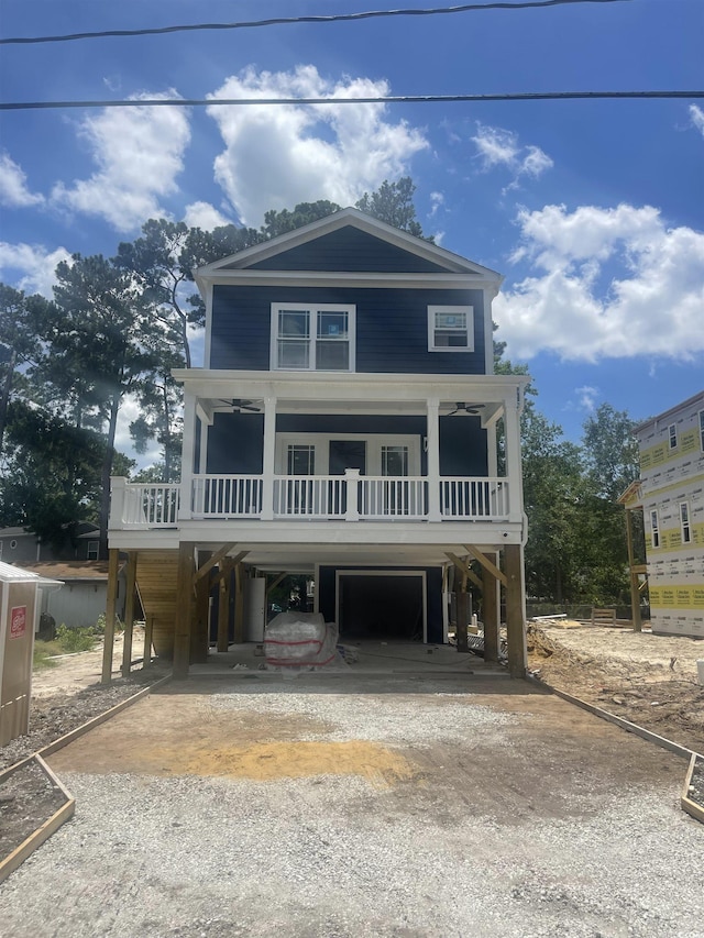 721 10th Ave S, Surfside Beach, SC 29575 - beach home with driveway, a carport, a porch, and a garage