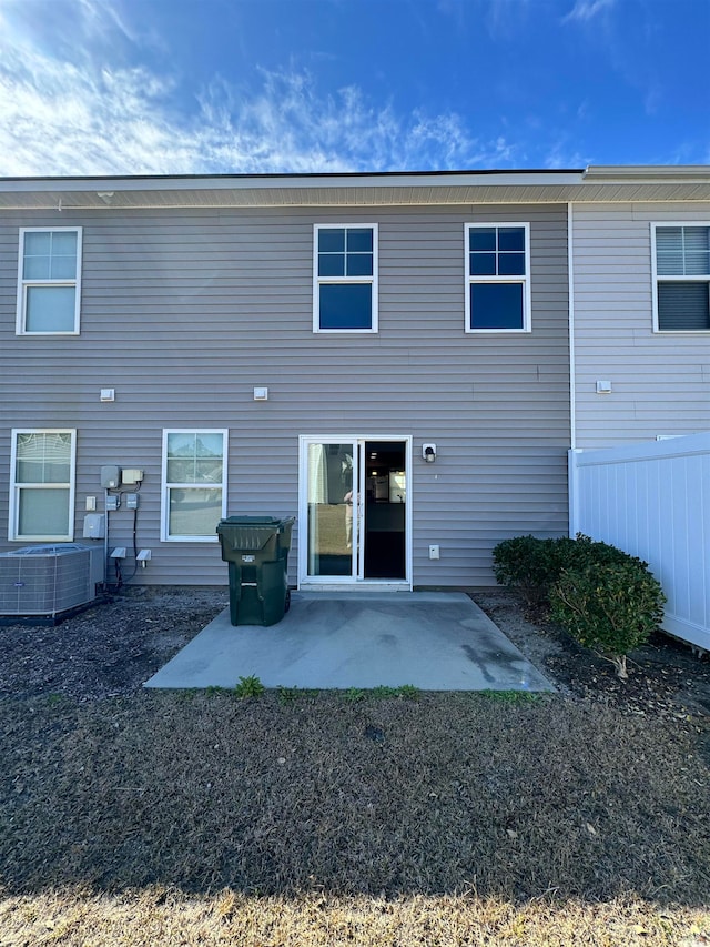 back of property featuring central air condition unit and a patio