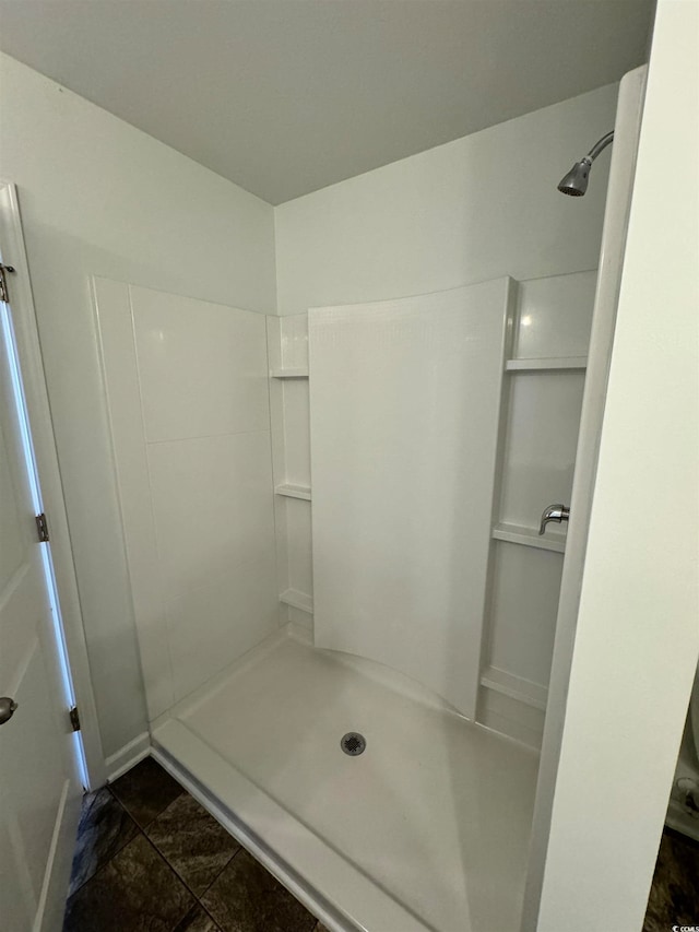 bathroom featuring walk in shower and tile floors