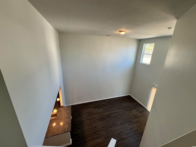 unfurnished room featuring dark hardwood / wood-style flooring