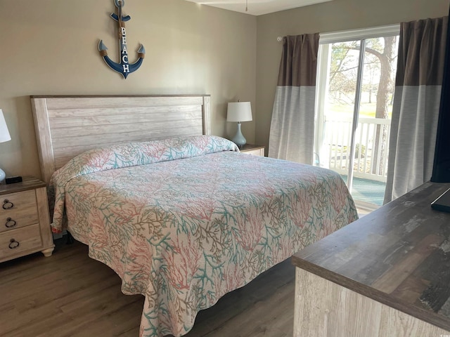 bedroom with dark hardwood / wood-style flooring and access to exterior