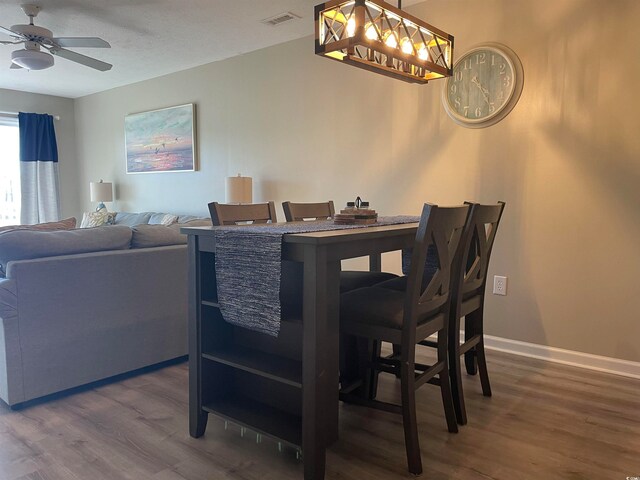 dining space featuring ceiling fan and dark hardwood / wood-style floors