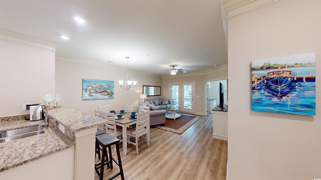 35 Delray Dr Unit 1-D, Murrells Inlet, SC 29576 - interior space with light stone countertops, light wood-style flooring, a sink, and ornamental molding