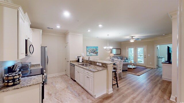 35 Delray Dr Unit 1-D, Murrells Inlet, SC 29576 - kitchen featuring a sink, open floor plan, a kitchen bar, appliances with stainless steel finishes, and visible vents