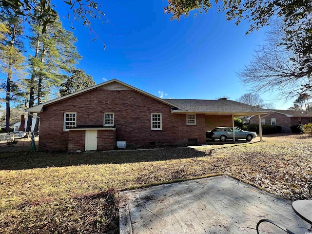 exterior space featuring a carport and a yard