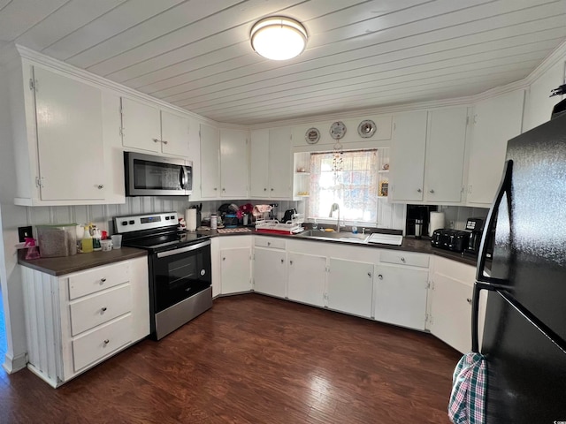 kitchen with dark hardwood / wood-style flooring, white cabinets, tasteful backsplash, and stainless steel appliances