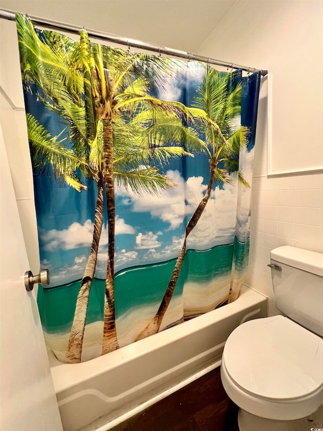 bathroom featuring tile walls, shower / bath combination with curtain, toilet, and hardwood / wood-style floors