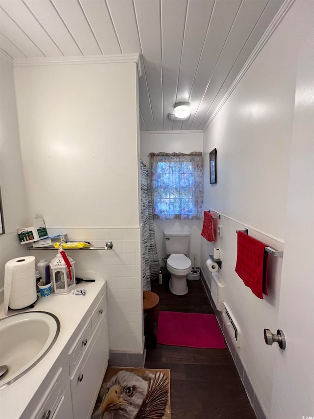 bathroom with hardwood / wood-style flooring, ornamental molding, vanity, and toilet