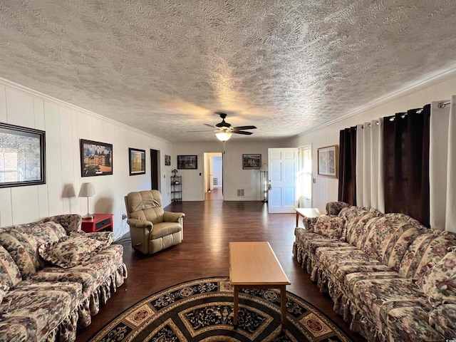 living area with dark hardwood / wood-style flooring, a textured ceiling, and a fireplace