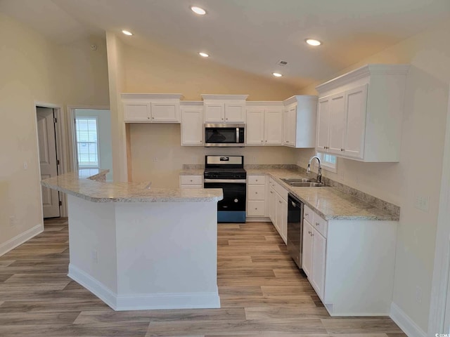 kitchen featuring white cabinetry, appliances with stainless steel finishes, and a kitchen island