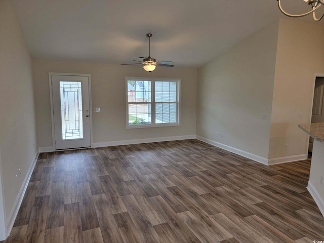 unfurnished living room featuring ceiling fan and dark hardwood / wood-style flooring