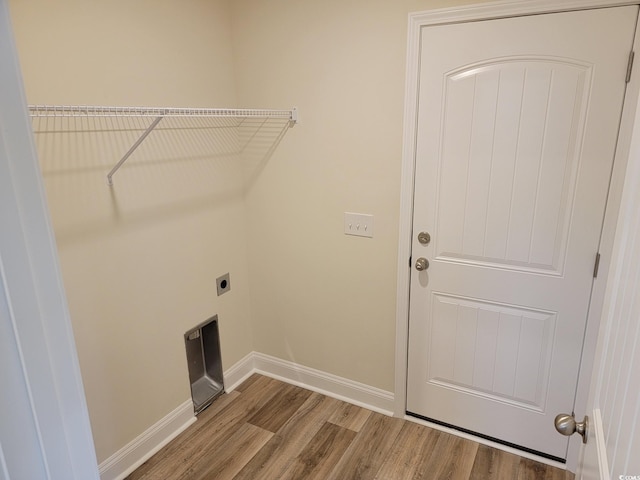 clothes washing area with hardwood / wood-style flooring and electric dryer hookup