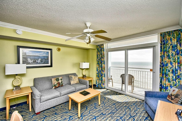 living room with ceiling fan, a water view, a textured ceiling, dark colored carpet, and crown molding