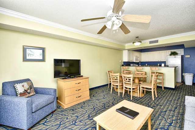 carpeted living room featuring ceiling fan, crown molding, and a textured ceiling