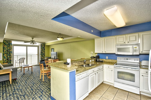 kitchen featuring ceiling fan, white appliances, and a textured ceiling