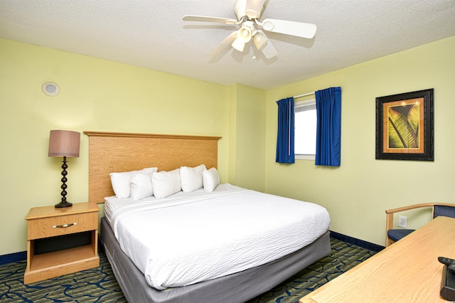 bedroom featuring ceiling fan and a textured ceiling