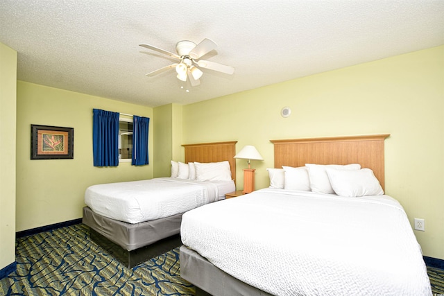 bedroom with ceiling fan and a textured ceiling