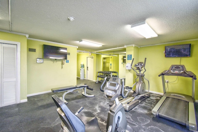 gym with ornamental molding and a textured ceiling