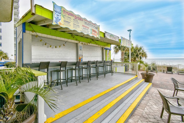 exterior space featuring a wooden deck and an outdoor bar