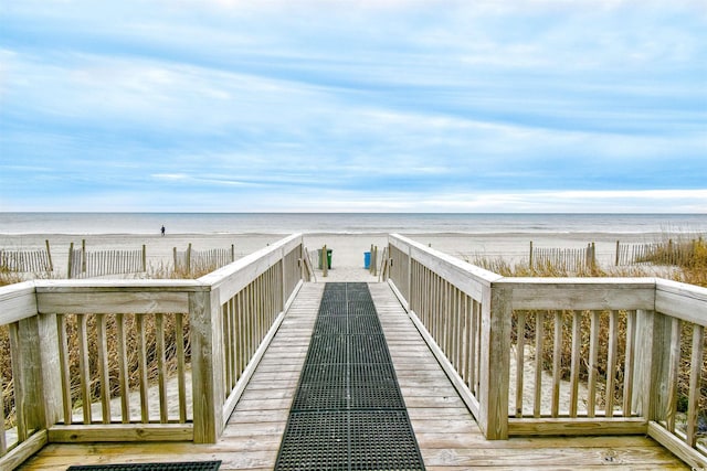 view of property's community featuring a beach view and a water view