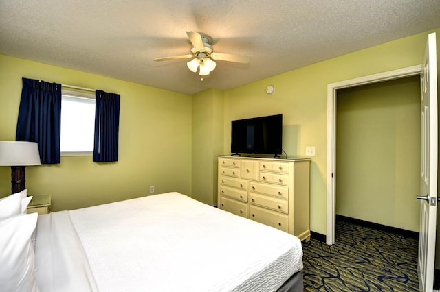 bedroom with ceiling fan and a textured ceiling