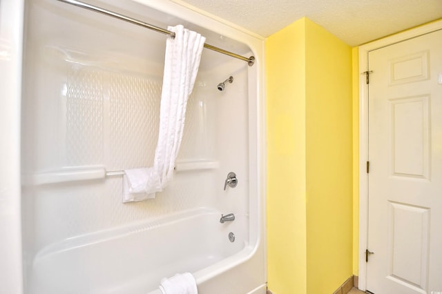 bathroom featuring a textured ceiling and shower / bath combo with shower curtain