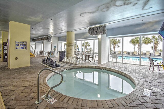 view of pool with a jacuzzi