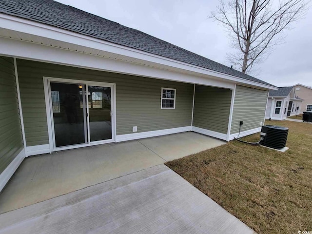 rear view of house featuring a yard, a patio, and central AC unit