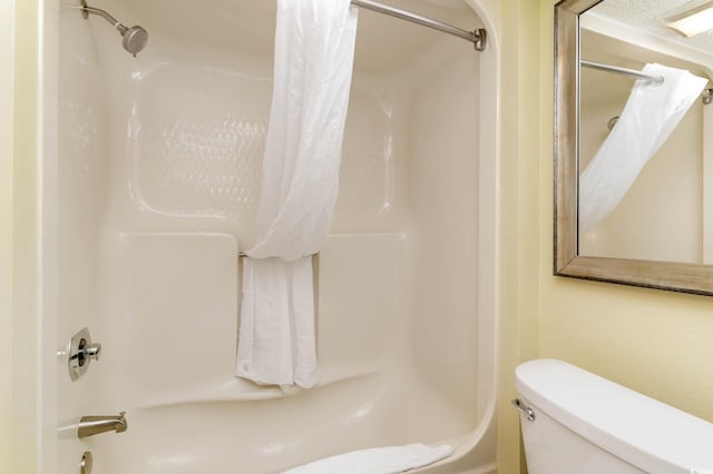 bathroom with toilet and shower / tub combo with curtain