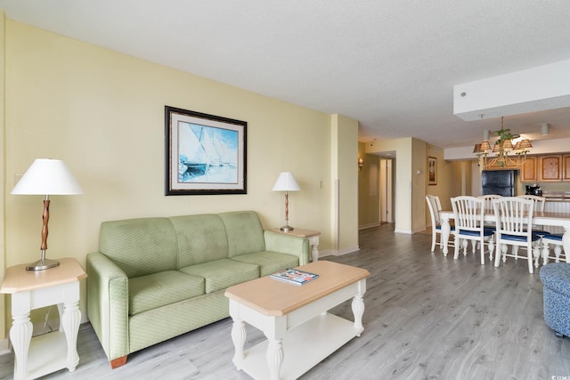 living room with light hardwood / wood-style flooring and a textured ceiling