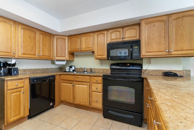 kitchen featuring sink, a textured ceiling, black appliances, and light tile flooring