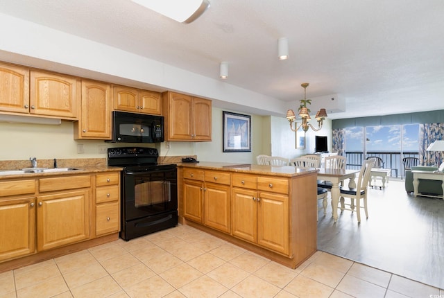 kitchen featuring light tile floors, decorative light fixtures, sink, a chandelier, and black appliances