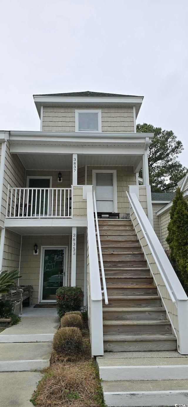 view of front of house featuring a balcony