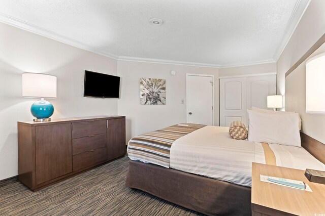 1105 S Ocean Blvd Unit 904, Myrtle Beach, SC 29577 - bedroom featuring crown molding, dark carpet, and a closet