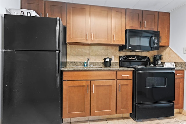 1105 S Ocean Blvd Unit 904, Myrtle Beach, SC 29577 - kitchen featuring decorative backsplash, a sink, black appliances, dark stone countertops, and light tile patterned flooring