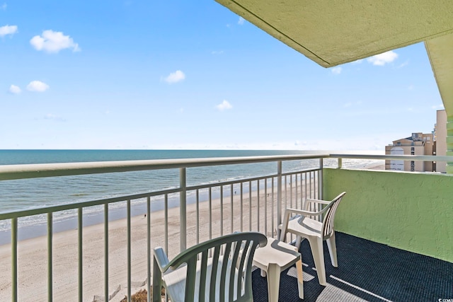 balcony featuring a water view and a view of the beach