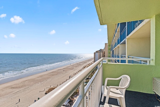 balcony with a water view and a beach view