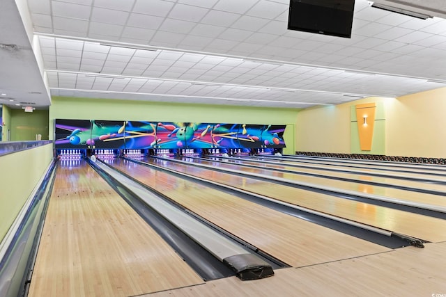 recreation room with light hardwood / wood-style floors and a bowling alley