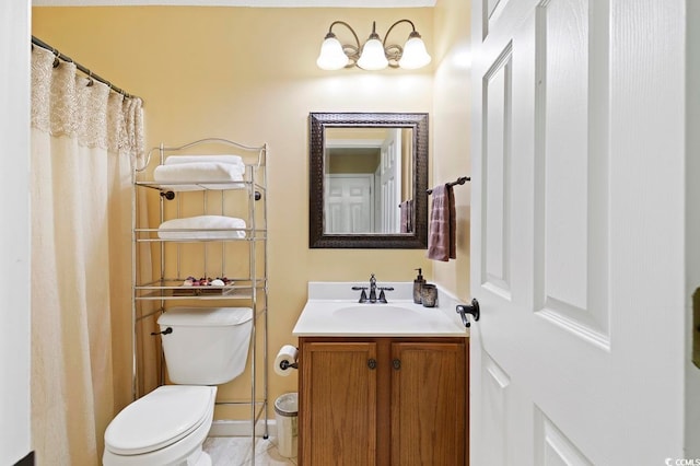 bathroom with vanity, tile floors, and toilet