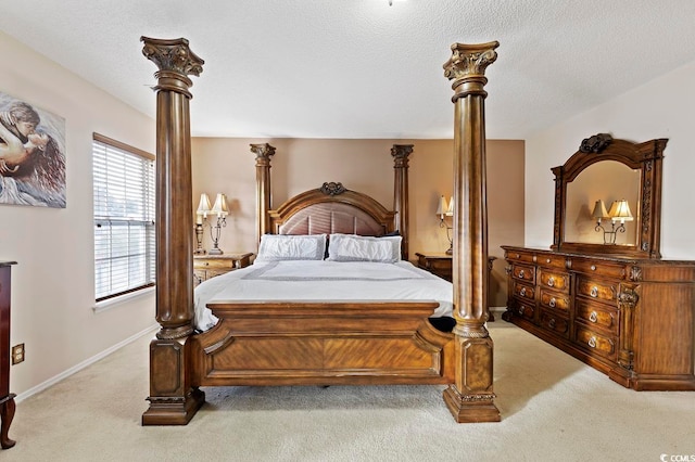 bedroom with a textured ceiling and light carpet