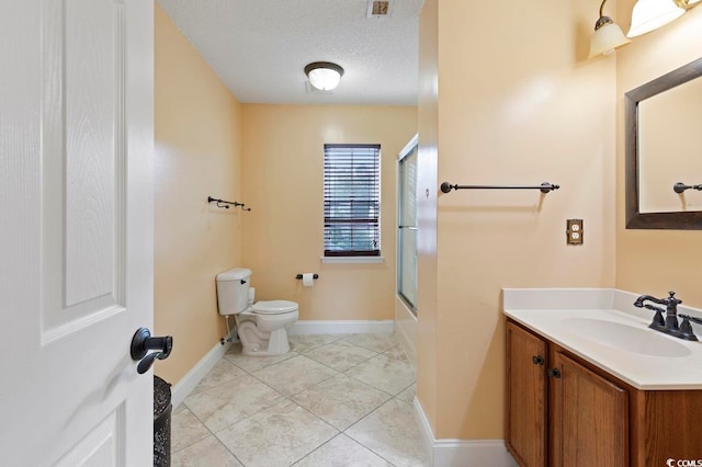 full bathroom featuring tile flooring, a textured ceiling, enclosed tub / shower combo, toilet, and vanity