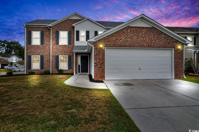 view of front of house with a garage and a lawn