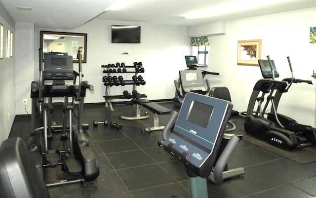 workout area featuring dark tile floors