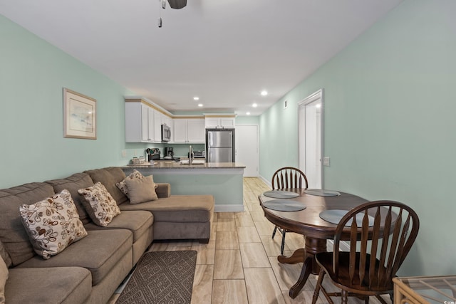 living room with ceiling fan and sink