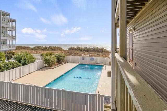 view of pool featuring a water view and a patio area