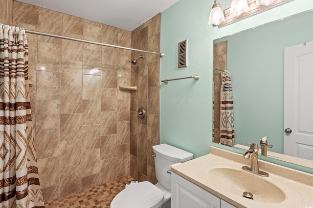 bathroom with toilet, vanity, and a shower with curtain